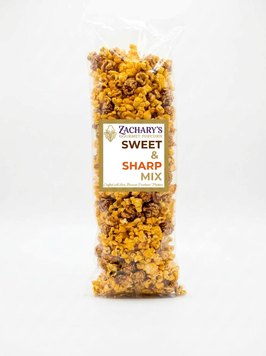 A clear plastic bag of Zachary's Sweet & Sharp Mix popcorn, showing the golden-yellow and brown caramelized popcorn pieces inside, with a white and gold label on a white background.