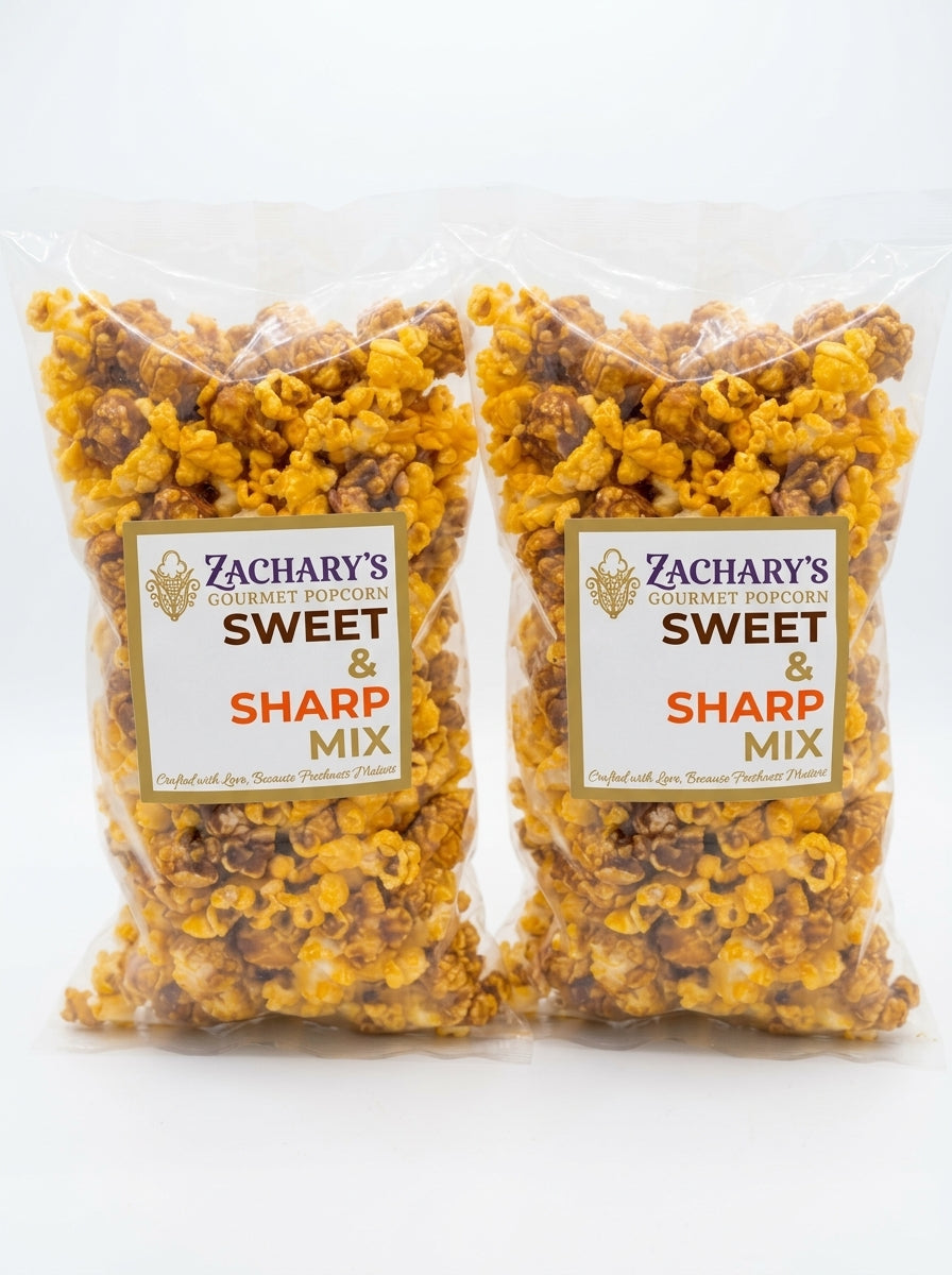 Two clear plastic bags of Zachary's Gourmet Food Works Sweet & Sharp Mix popcorn, showing the golden-brown and yellow popcorn inside, set against a plain white background.