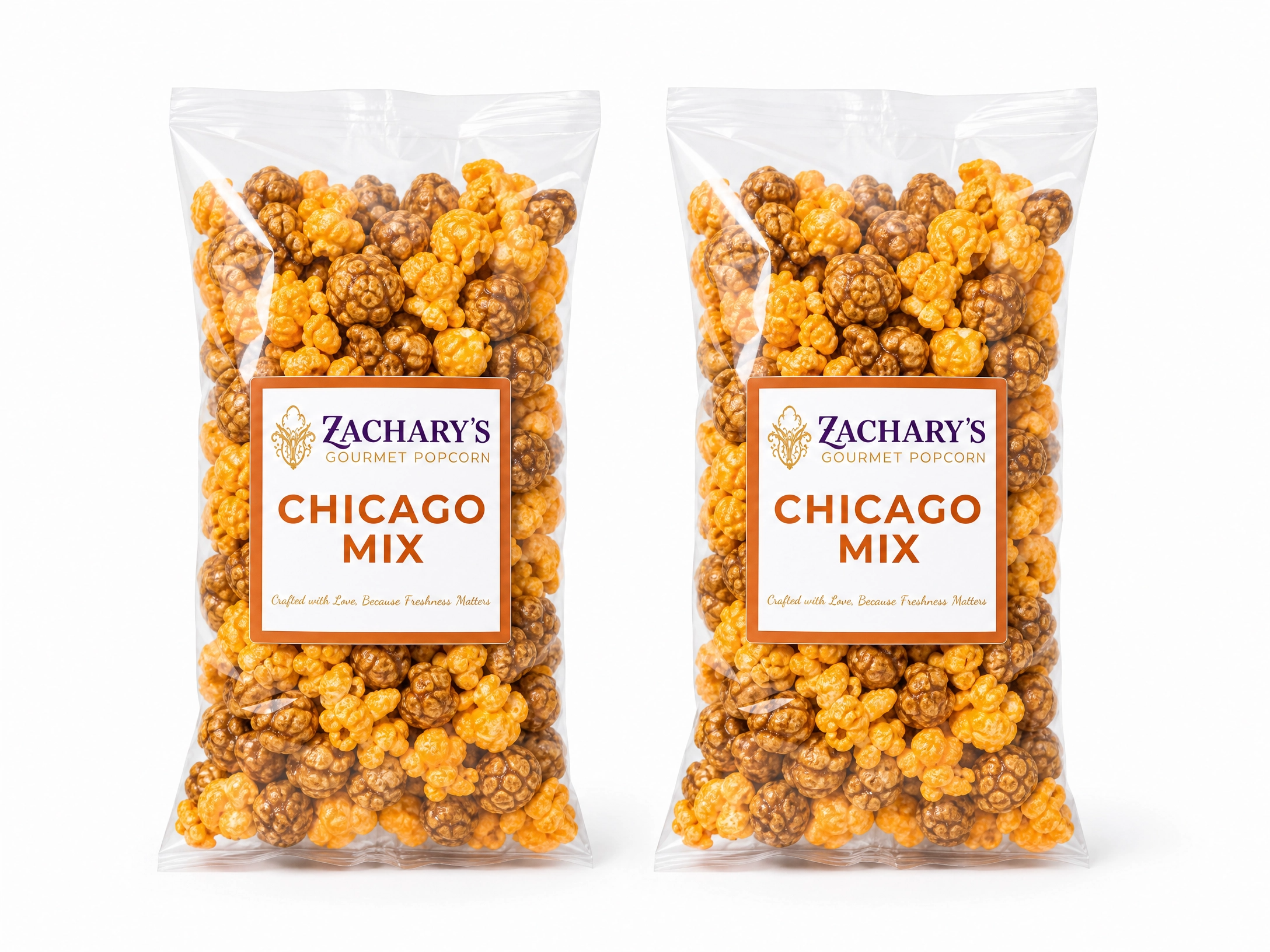 Two bags of Zachary's Chicago Mix gourmet popcorn side by side, caramel and cheddar kernel blend with orange and white label