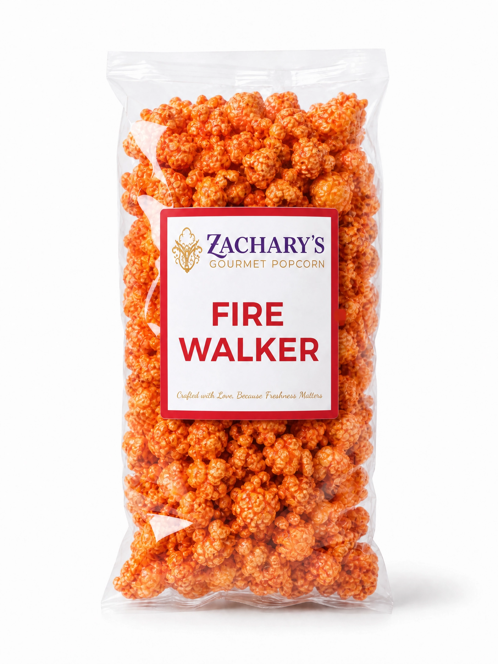 Bag of Zachary's Fire Walker gourmet popcorn, bright orange spicy-coated kernels in a clear bag with red and white label