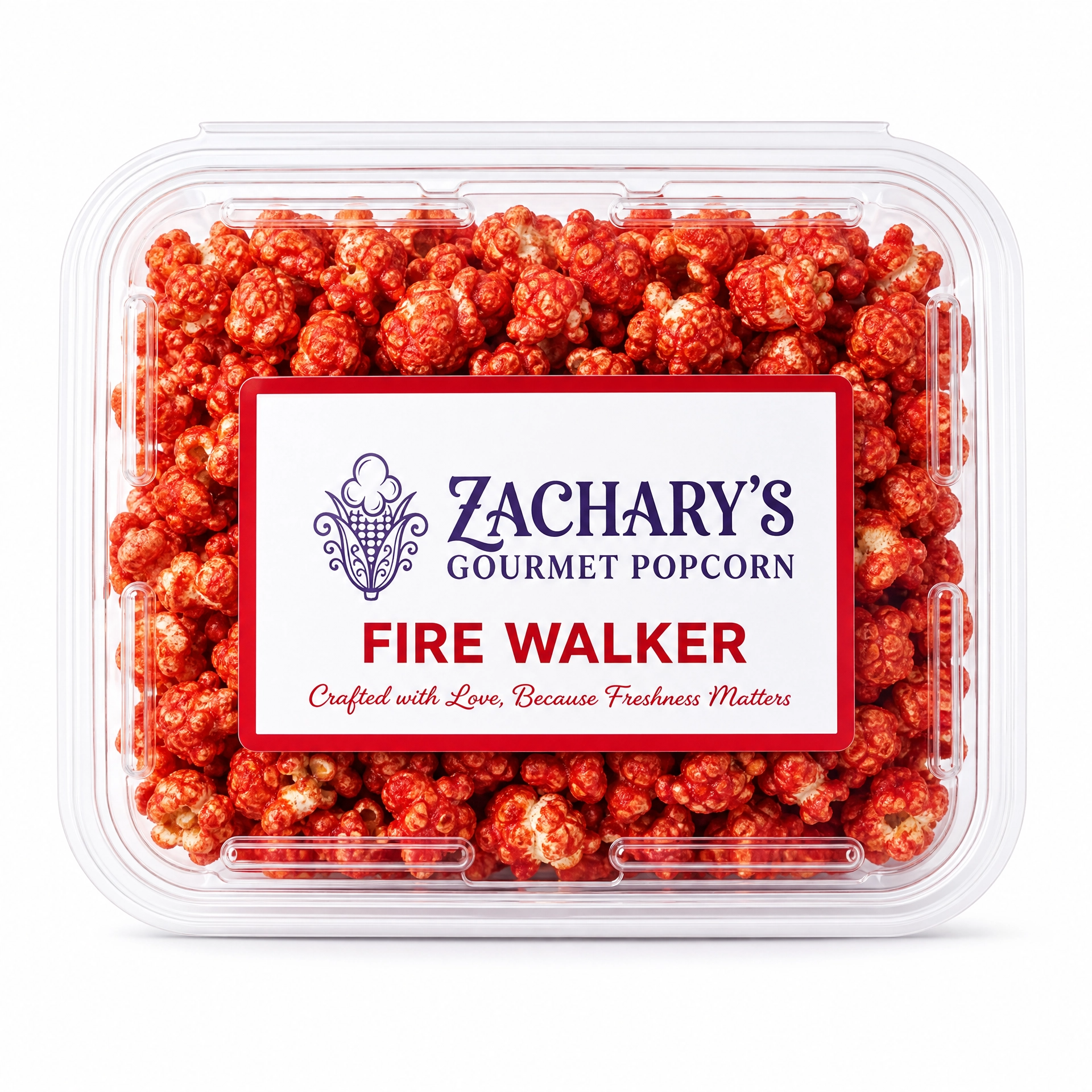 Close-up of Zachary's Fire Walker gourmet popcorn in a clear clamshell container, red spicy-coated kernels with red and white label