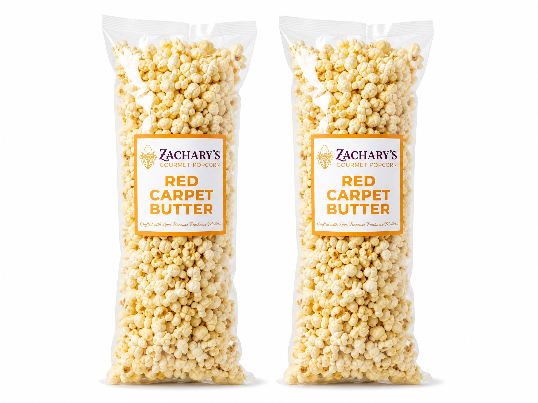 Two large bags of Zachary's Red Carpet Butter gourmet popcorn, classic golden buttery kernels with gold and white label