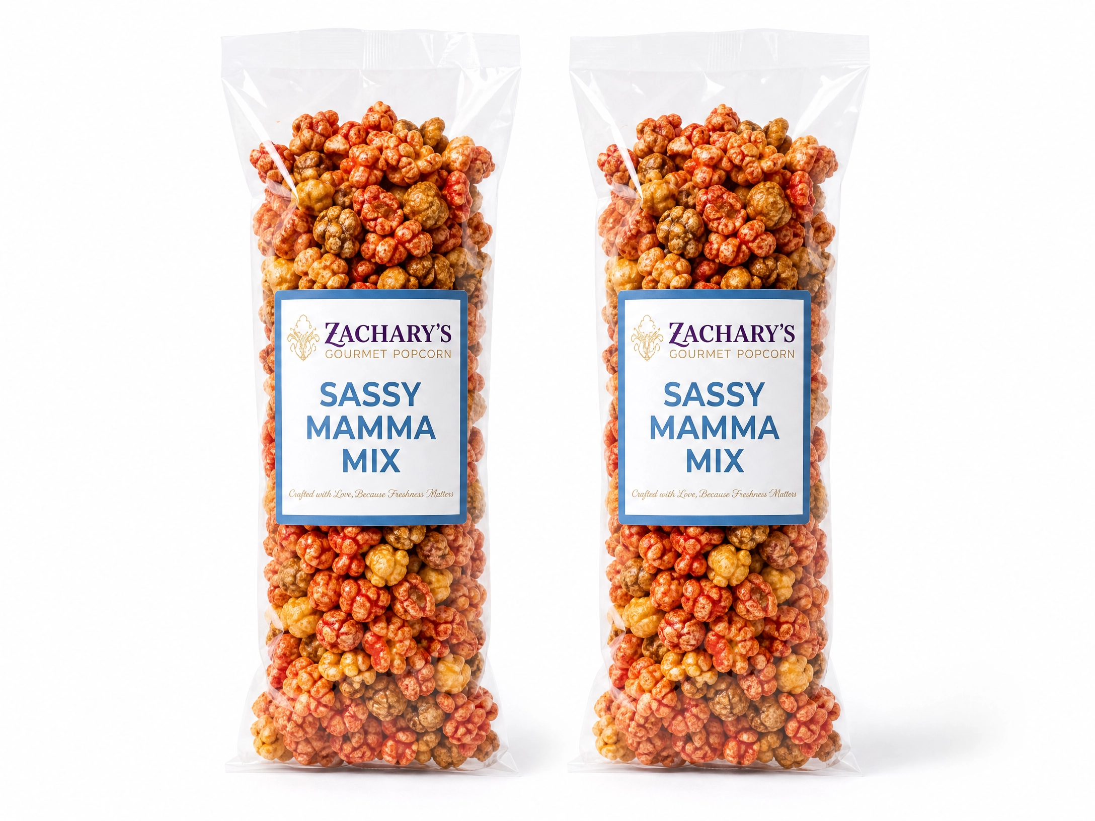 Two bags of Zachary's Sassy Mamma Mix gourmet popcorn, sweet and savory caramel-Cheddar, spicy kernel blend with blue and white label