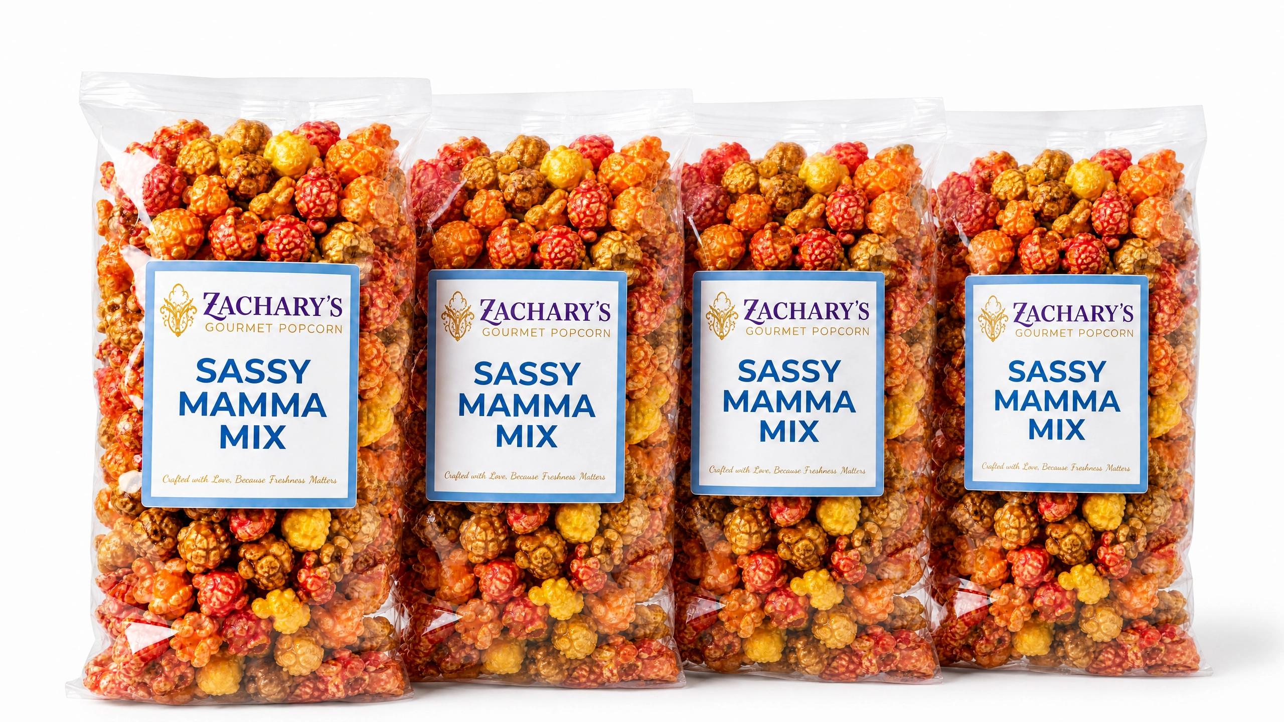 Four bags of Zachary's Sassy Mamma Mix gourmet popcorn, sweet and savory caramel-Cheddar, spicy kernel blend with blue and white label