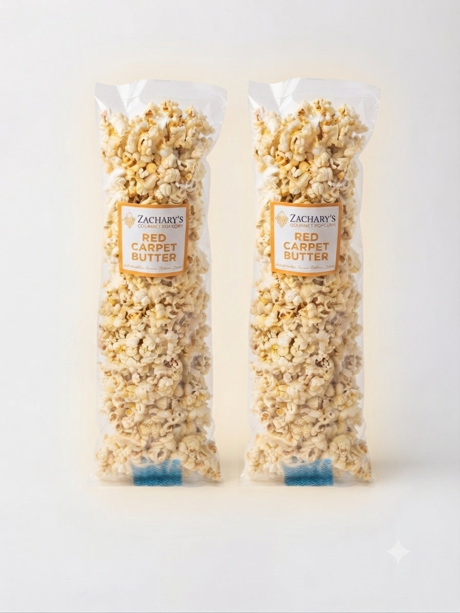 Two clear plastic bags of Zachary's Red Carpet Butter popcorn standing upright against a clean white background.